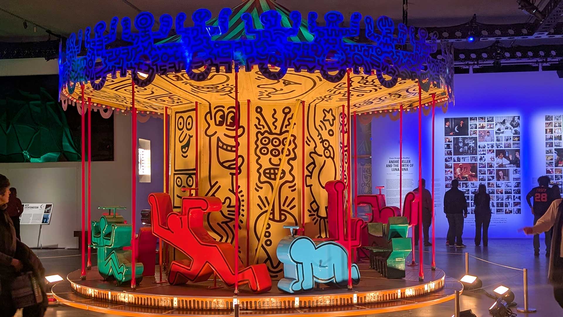 Keith Haring painted carousel installation for the Luna Luna art exhibition, colorful pop art sculpture, immersive contemporary art display, iconic Keith Haring artwork.