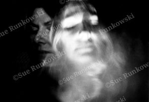 Black-and-white self-portrait featuring blurred ghostly face, creating an expressive, moody fine art photograph.