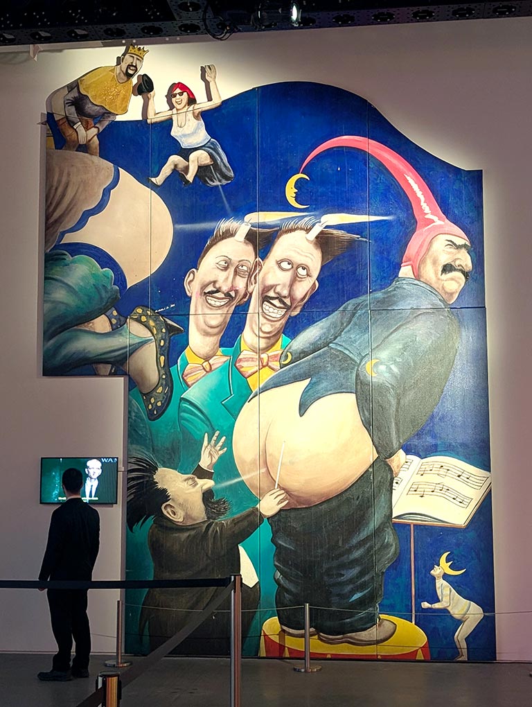 Painted Manfred Deix Mural Palace of Winds mural of a man farting in a music conductors face