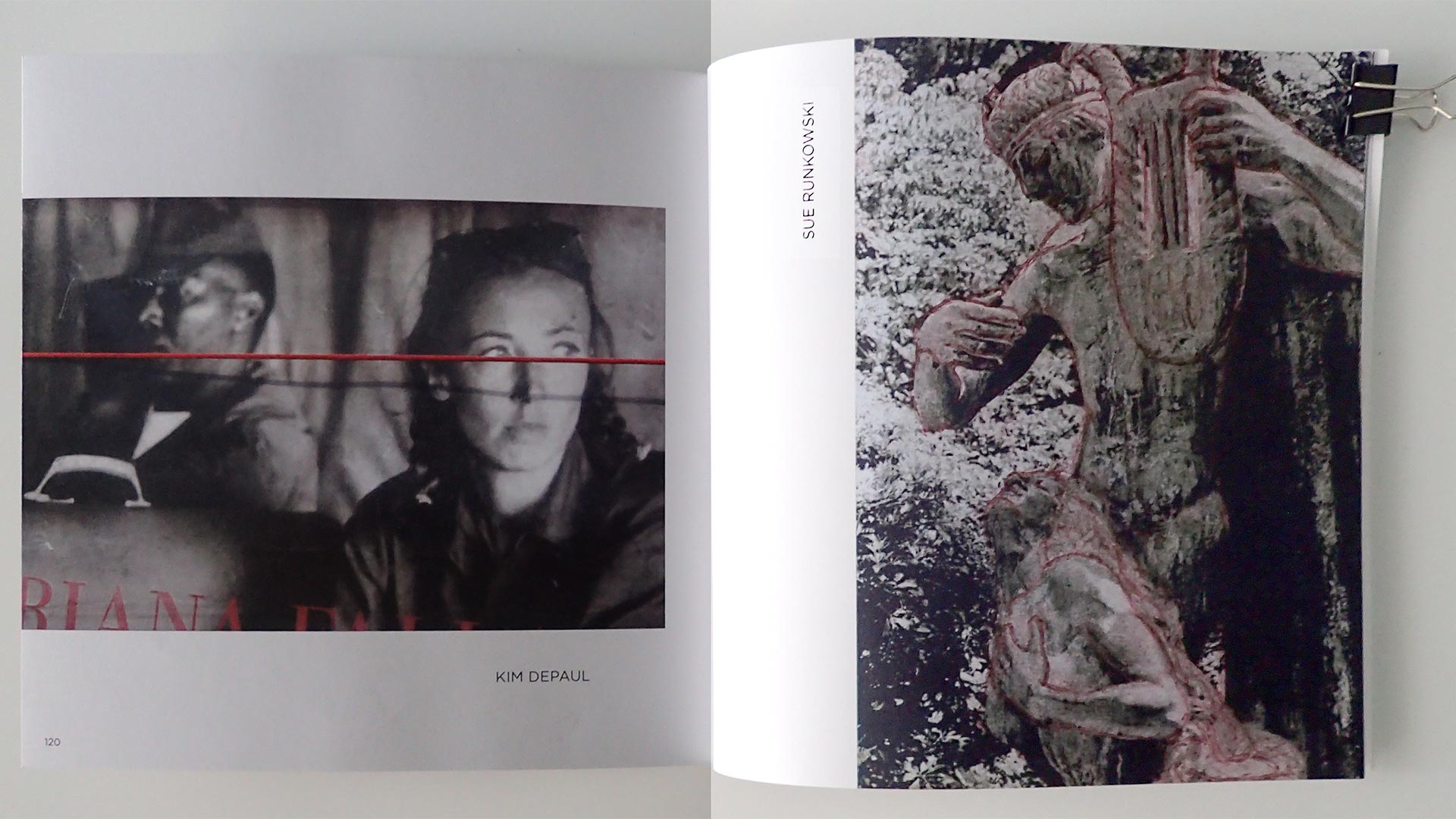 An open Maine Media Workshops College Exquisite Corpse Volume 2 book displays a two-page spread of artwork. On the left page is a black-and-white photograph of two people seated side by side, overlaid with a thin horizontal red line crossing their faces. On the right page is a textured, monochrome image of a human-like stone or sculptural figure outdoors, outlined with red markings; the name “Sue Runkowski” is printed vertically along the inner margin.